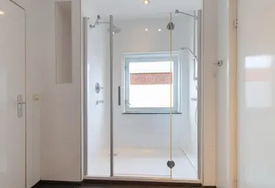 a glass shower in a bathroom with a window at ApartHotel Trendy by Urban Home Stay in Alkmaar