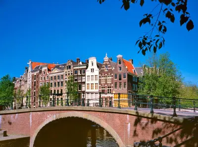 a bridge over a river in front of buildings at WestCord City Centre Hotel in Amsterdam