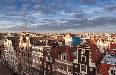 an aerial view of a city with buildings and roofs at WestCord City Centre Hotel in Amsterdam