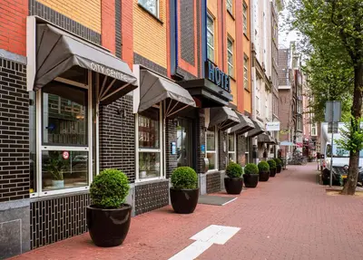 a street with a row of plants in front of a store at WestCord City Centre Hotel in Amsterdam