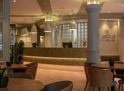 a lobby of a restaurant with tables and chairs at WestCord City Centre Hotel in Amsterdam