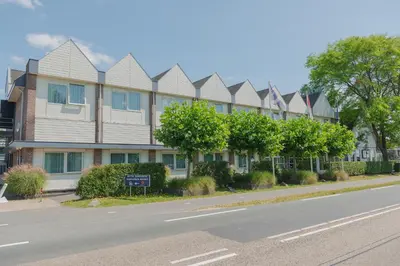 a row of houses on the side of a street at Boutique Hotel Herbergh Amsterdam Airport FREE PARKING in Badhoevedorp