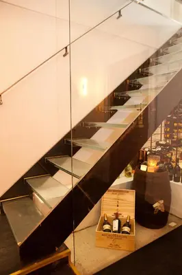 a staircase in a store with glass shelves at Vesper Hotel in Noordwijk aan Zee