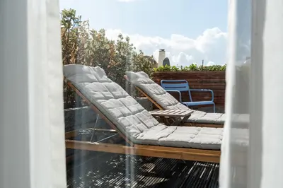 a pair of chairs sitting on a balcony at Vesper Hotel in Noordwijk aan Zee