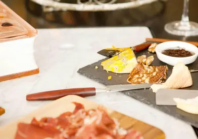a table with a plate of food and a knife at Vesper Hotel in Noordwijk aan Zee