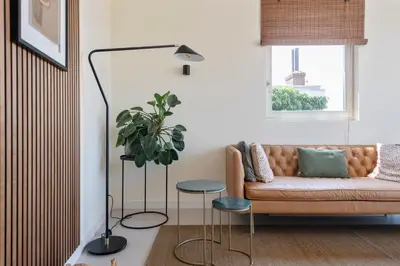 a living room with a couch and a potted plant at The Modern Burrow in Zandvoort