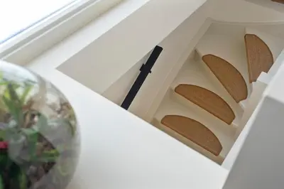a clock in a white drawer next to a plant at The Modern Burrow in Zandvoort