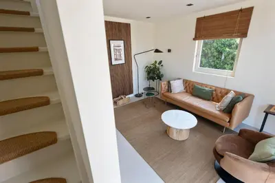 a living room with a couch and a table at The Modern Burrow in Zandvoort