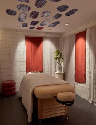 a bedroom with a bed in a room with windows at Pulitzer Amsterdam in Amsterdam