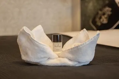 a bottle of moisturizing moisturizers in a white towel at Amsterdam Hotel Uithoorn in Uithoorn