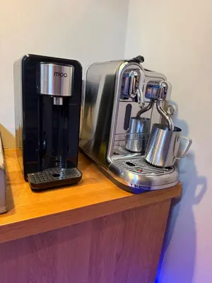 two coffee machines sitting on a wooden shelf at Boat & Boost Amsterdam in Amsterdam