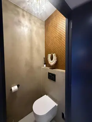 a bathroom with a white toilet and a chandelier at Boat & Boost Amsterdam in Amsterdam