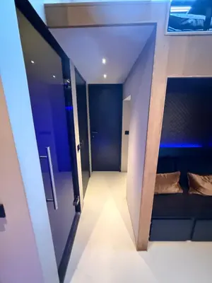 a room with a corridor with blue walls and a mirror at Boat & Boost Amsterdam in Amsterdam