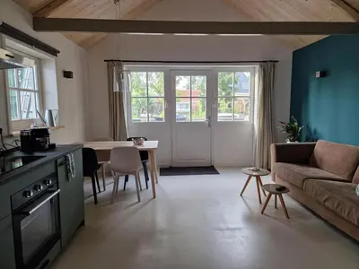 a living room with a couch and a table at Fenix Edam in Edam