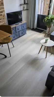 a living room with a television and a table at zomerhuis in Wijk aan Zee! 2 pers in Wijk aan Zee