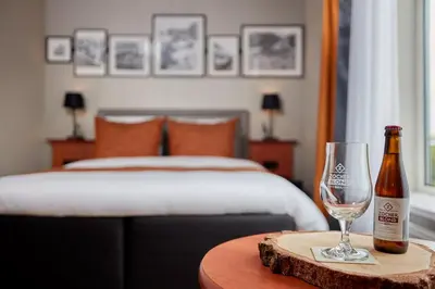a bottle of champagne and a wine glass on a table at Carlton Square Hotel in Haarlem