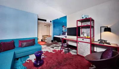 a living room with a blue couch and a table at Carlton Square Hotel in Haarlem