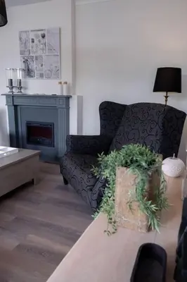 a living room with a couch and a fireplace at Vakantiebungalow Limmen in Limmen