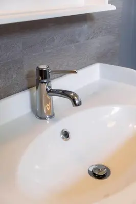 a bathroom sink with a faucet on top of it at Vakantiebungalow Limmen in Limmen