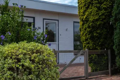 a house with a wooden fence in front of it at Vakantiebungalow Limmen in Limmen