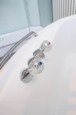 a bathroom sink with a faucet on a toilet at Vakantiebungalow Limmen in Limmen