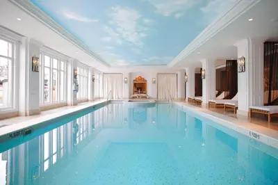 a large swimming pool in a room with a ceiling at InterContinental Amstel Amsterdam by IHG in Amsterdam
