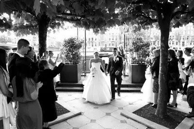 a bride and groom walking down the aisle at their wedding at InterContinental Amstel Amsterdam by IHG in Amsterdam