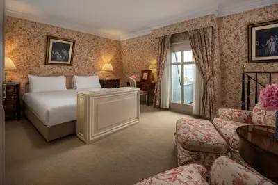 a hotel room with a bed and a chair at InterContinental Amstel Amsterdam by IHG in Amsterdam