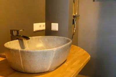 a concrete sink sitting on top of a wooden counter at B&B Vechtzicht in Weesp