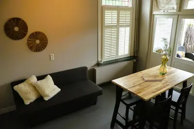 a living room with a couch and a wooden table at B&B Vechtzicht in Weesp