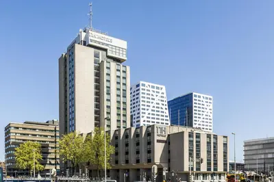 a group of tall buildings in a city at NH Utrecht in Utrecht