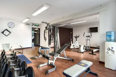 a gym with several exercise equipment in a room at NH Utrecht in Utrecht