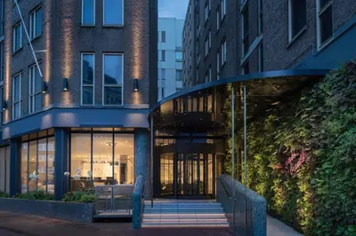 an entrance to a building with glass doors at Kimpton De Witt Amsterdam by IHG in Amsterdam