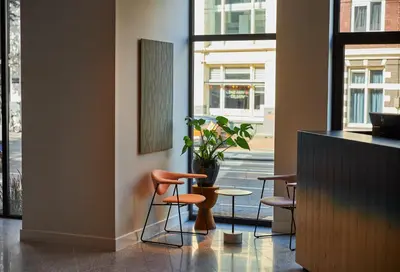 a room with chairs and a table and a window at Kimpton De Witt Amsterdam by IHG in Amsterdam