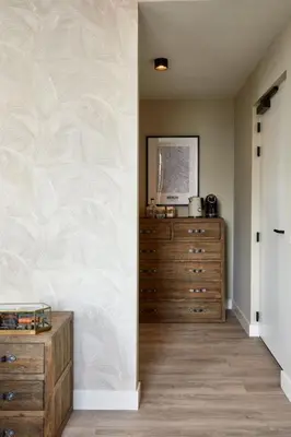 a bedroom with a dresser and a wall with a mural at Brasserie Spoorhuis Mijdrecht in Mijdrecht