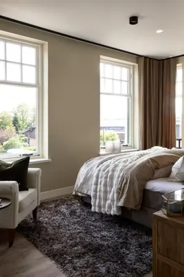 a bedroom with a bed and two windows at Brasserie Spoorhuis Mijdrecht in Mijdrecht
