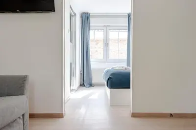 a room with a mirror and a bed and a window at Studio Duinzand in Zandvoort