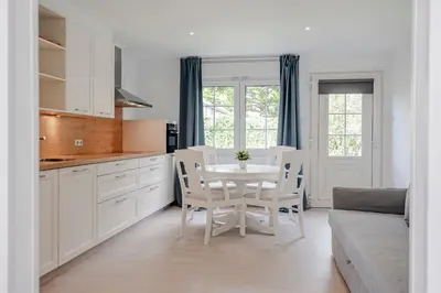 a kitchen and dining room with a table and chairs at Studio Duinzand in Zandvoort