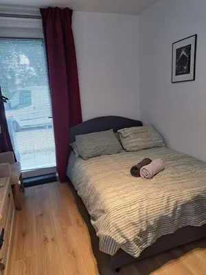 a bedroom with a bed with a teddy bear on it at Dubbelink 3A in Amsterdam