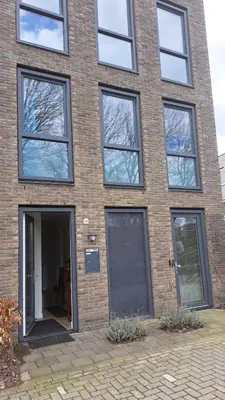 a brick building with windows and a door at Dubbelink 3A in Amsterdam