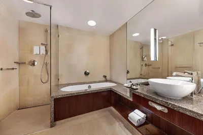 a bathroom with a tub and a sink and a shower at Hotel Okura Amsterdam – The Leading Hotels of the World in Amsterdam