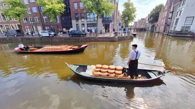 a man is standing in a boat on a river at Finse Kota met privé Sauna en Hottub in Spanbroek