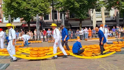 a group of men in yellow hats walking around a yellow raft at Finse Kota met privé Sauna en Hottub in Spanbroek