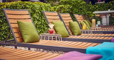 a row of chairs with green pillows on them at WestCord Art Hotel Amsterdam 3 stars in Amsterdam
