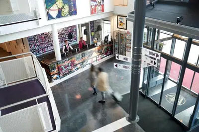 a person walking through a shopping mall at WestCord Art Hotel Amsterdam 3 stars in Amsterdam