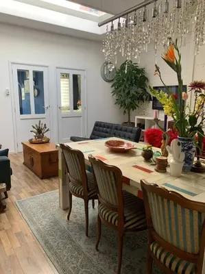 a living room with a dining room table with chairs at De Bollenschuur in Egmond aan Zee
