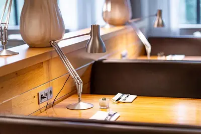 a desk with a lamp on top of a table at Holiday Inn Amsterdam - Arena Towers by IHG in Amsterdam