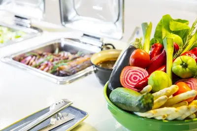 a bowl of vegetables on a counter with other foods at Holiday Inn Amsterdam - Arena Towers by IHG in Amsterdam