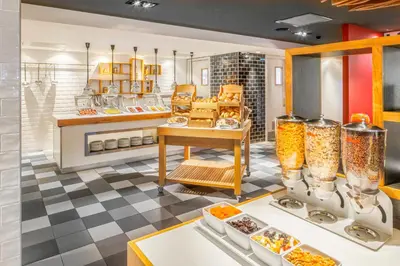 a kitchen with a buffet of food on display at Holiday Inn Amsterdam - Arena Towers by IHG in Amsterdam