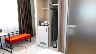 a room with a door and a chair and a desk at Holiday Inn Amsterdam - Arena Towers by IHG in Amsterdam